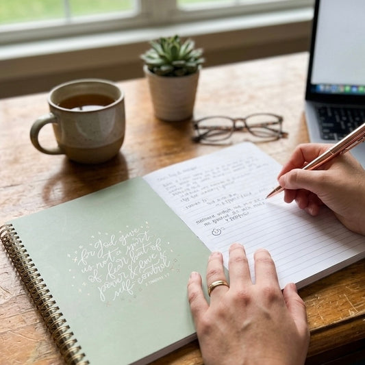 Cozy desk setup with a Sage Angelic prayer journal, highlighting a serene environment for reflection and spiritual growth.