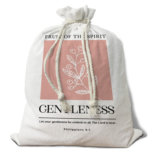 A front-facing studio shot of an unbleached linen drawstring bread bag featuring the words "Fruit of the Spirit: Gentleness" and a soft botanical illustration, designed for artisan sourdough storage