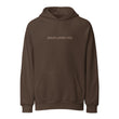 Isolated product view of a brown heavy-weight hoodie with the minimalist 'Jesus Loves You' text centered on the chest.