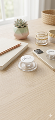 Aesthetic lifestyle mockup of the Christian "Grace" phone grip on a light oak wood desk next to a gold smartphone, a cream-colored prayer journal with a rose gold pen, a small succulent, and a woven basket for a peaceful, inspiring daily devotion setting.