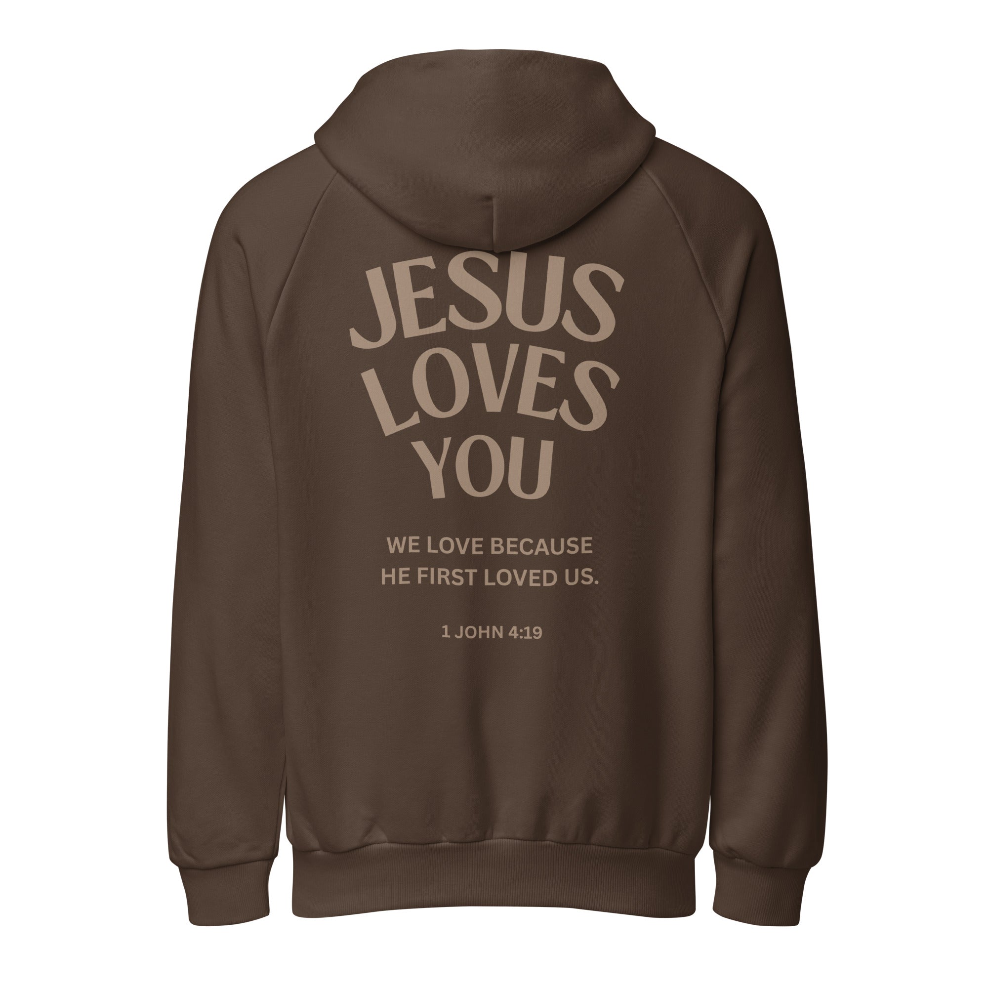 Isolated product view of a brown heavy-weight hoodie showing the back print design: 'Jesus Loves You' with 'We love because He first loved us. 1 John 4:19 Christian faith based apparel