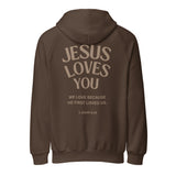 Isolated product view of a brown heavy-weight hoodie showing the back print design: 'Jesus Loves You' with 'We love because He first loved us. 1 John 4:19 Christian faith based apparel