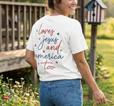 Woman styling a faith-based "loves jesus and america too" t-shirt in a summer garden.