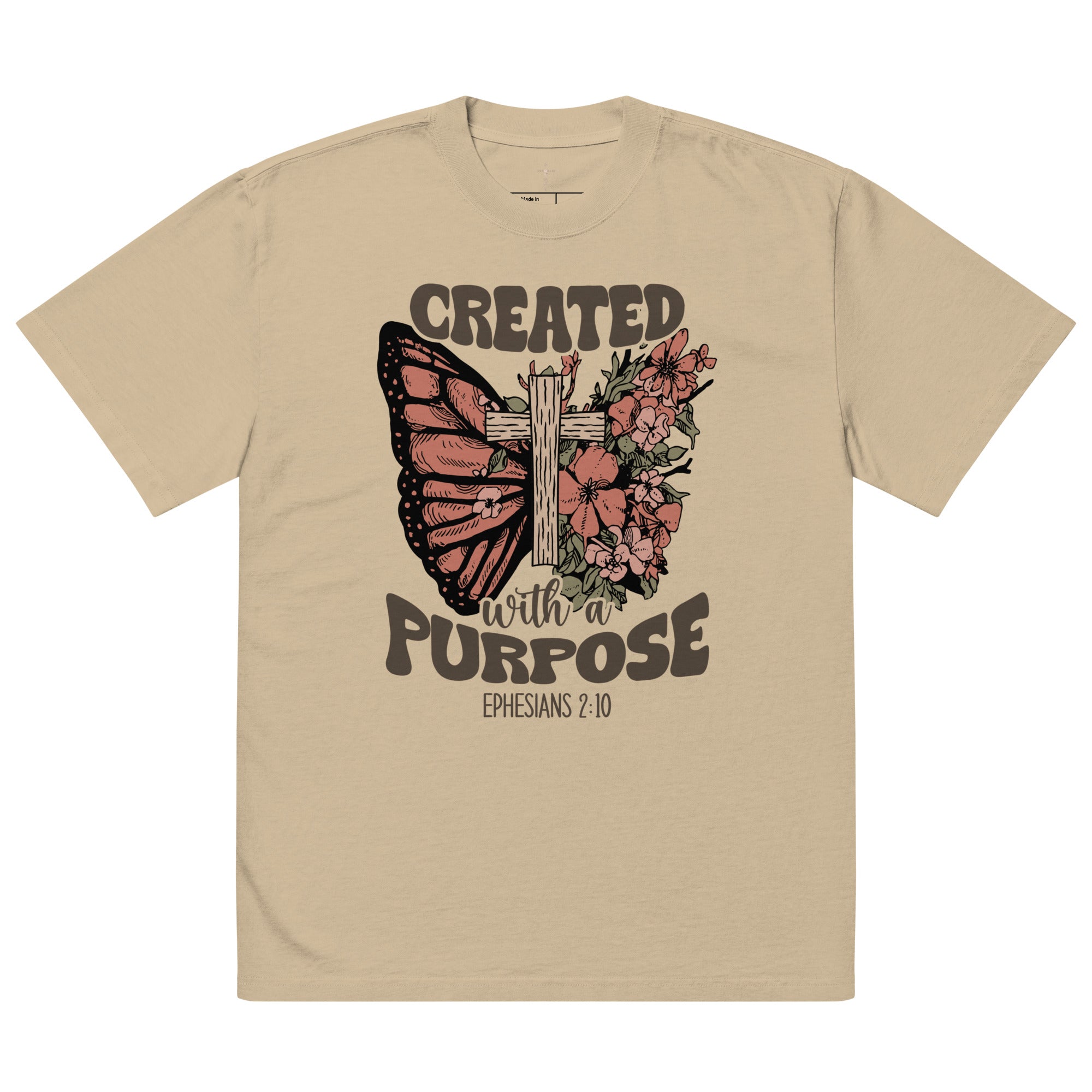 An isolated product view of a light tan(khaki) faded graphic t-shirt for Christians, featuring a butterfly and floral cross design with Ephesians 2:10.