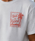 Detailed close-up of a red "God is Good" palm tree stamp design printed on a white faith-based Christian graphic t-shirt.