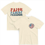 Cream-colored Faith, Family, and Freedom t-shirt with retro red and blue typography and a Christian-themed front emblem.