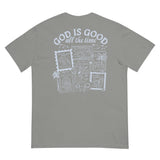 Flat lay back view of a grey inspirational Christian apparel shirt featuring a detailed "God is Good all the time" coastal stamp graphic.