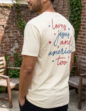 Man modeling a cream Christian apparel t-shirt with "loves jesus and america too" religious graphic on the back