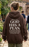 Lifestyle back view of person wearing brown unisex heavy weight hoodie with Jeremiah 29:11 Bible verse back print