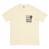 Flat lay front view of a cream minimalist Christian graphic tee with a black "God is Good" palm tree stamp design.
