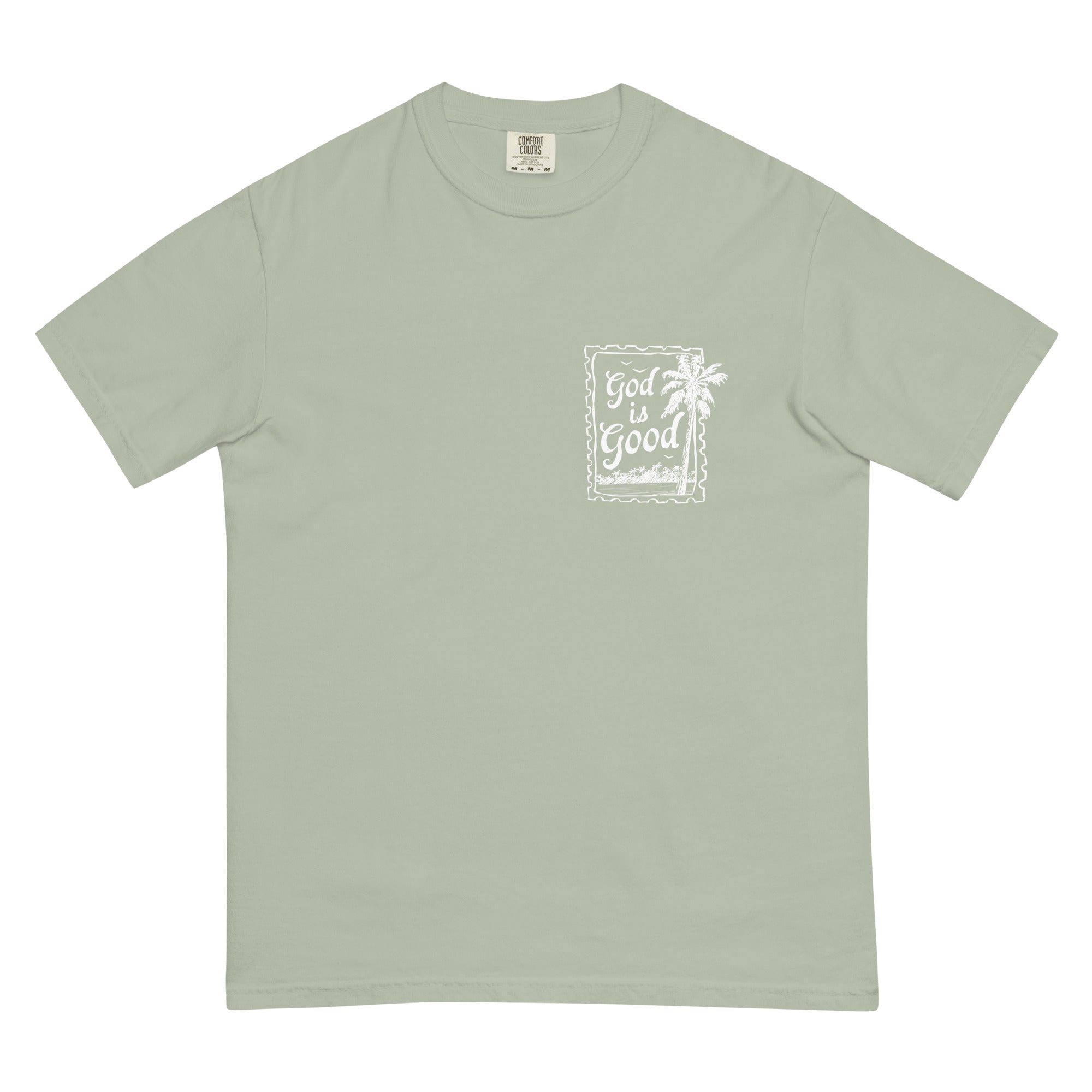 Flat lay of a sage green faith-based graphic tee featuring a minimalist "God is Good" palm tree stamp on the chest.