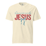 A front view of a cream-colored unisex heavyweight garment-dyed t-shirt featuring the America Needs Jesus graphic design